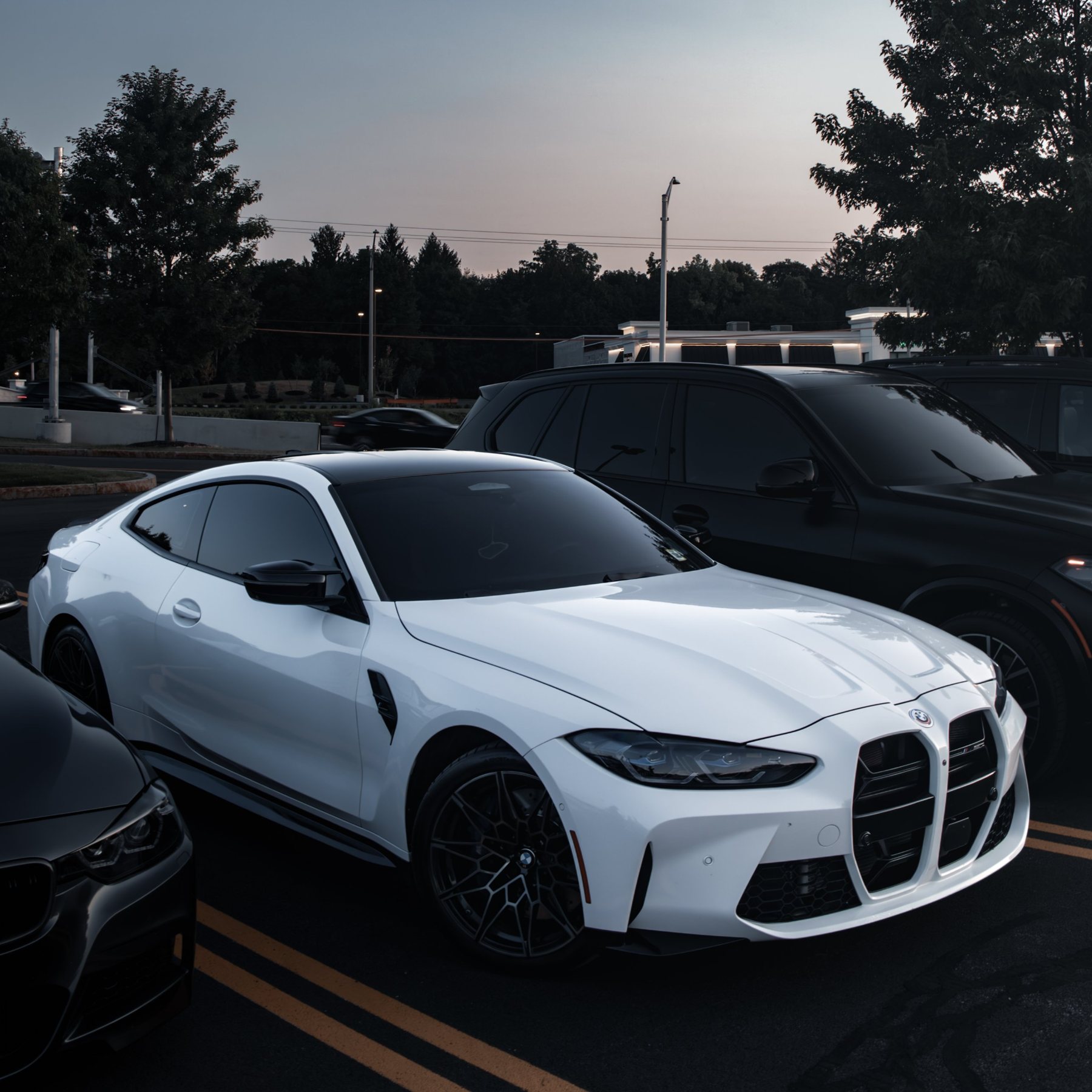 White BMW M4 coupe, dusk